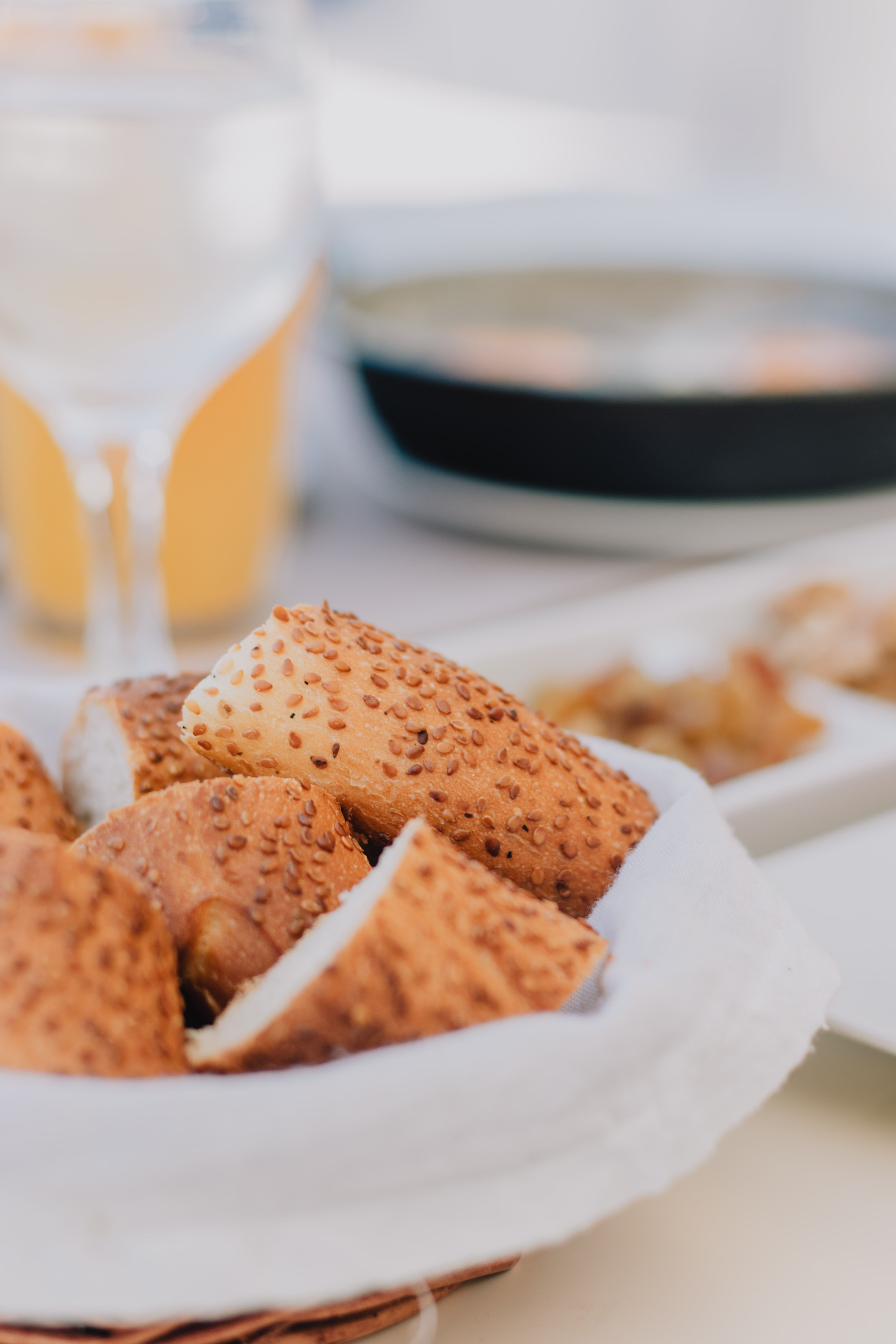 Close-up of sesame seed bread in a basket on a table, perfect for food photography.