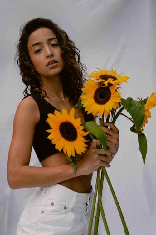 Woman Posing with Sunflowers