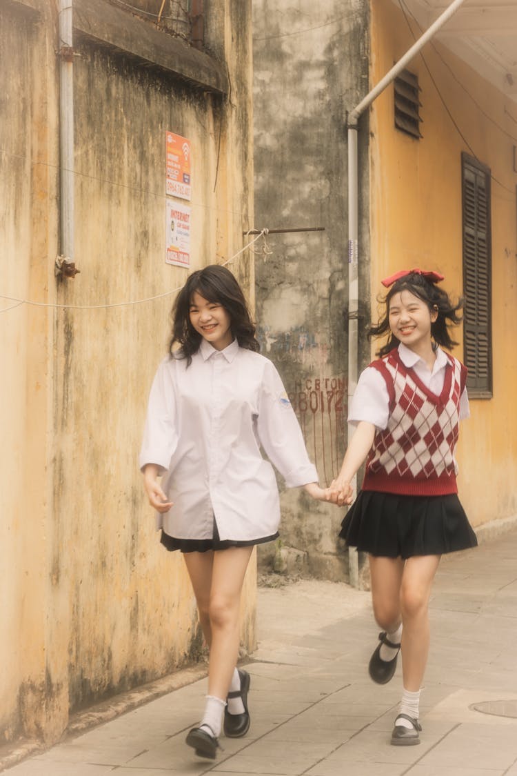 Girls In School Uniform Running On Street