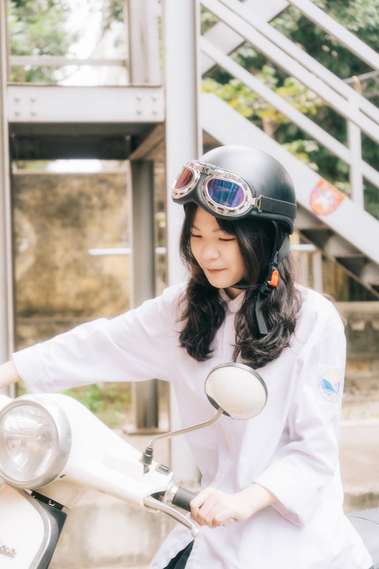 Woman In Helmet On Motor Scooter