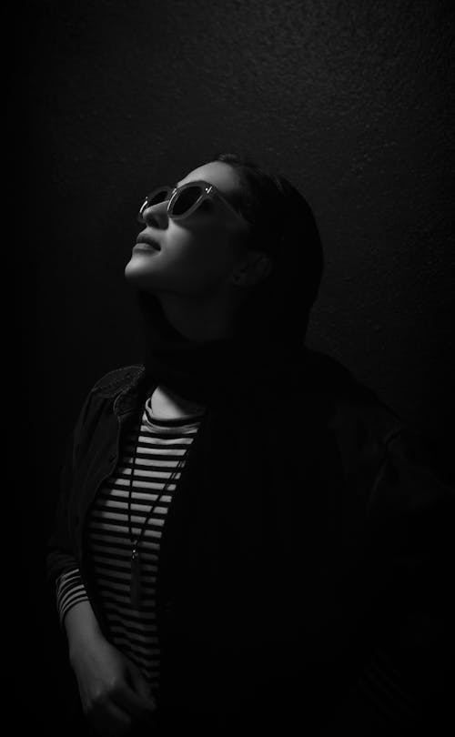 A Woman Wearing Sunglasses while Looking Up