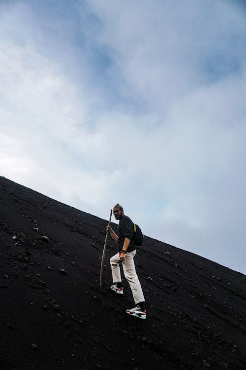 Man in Black Shirt Climbing Mountain