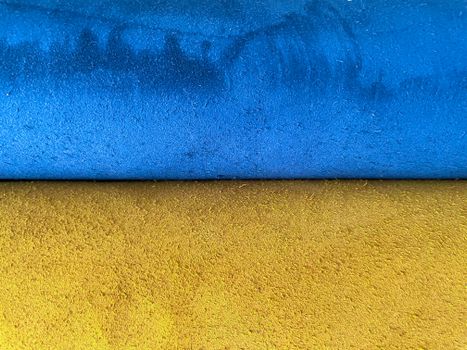 Textured surface with vibrant blue and yellow hues, ideal for abstract designs.