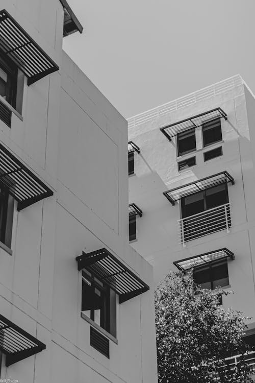 Low Angle Shot of White Building with Glass Windows