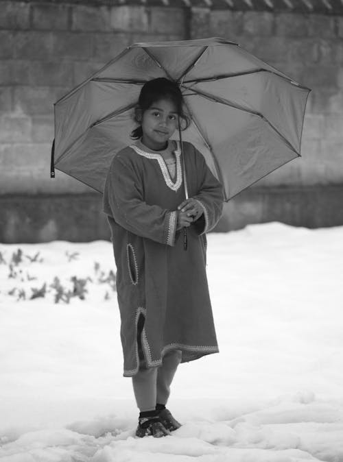 Grayscale Photo of Bird Holding Umbrella