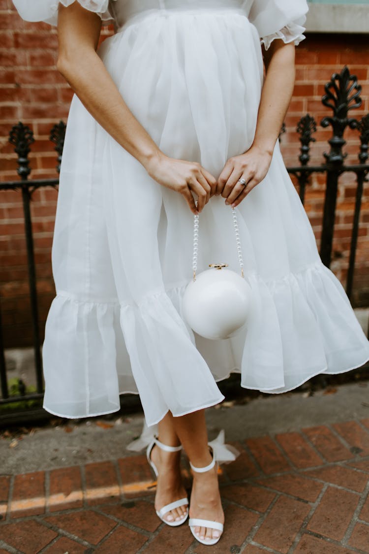 White Bag In Hands Of Woman In Wedding Dress