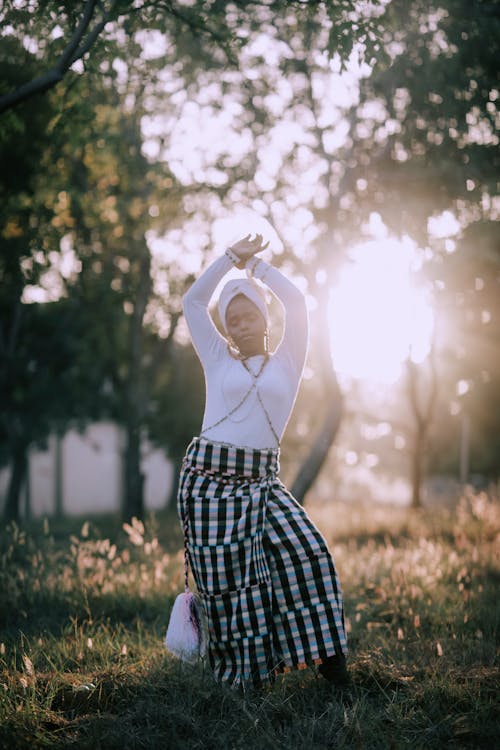 Woman Stretching under Sunlight