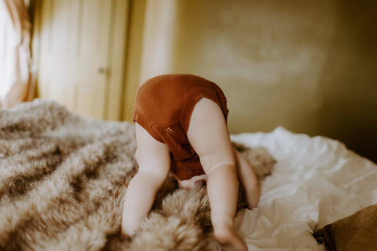 Cute Baby Playing In Bed