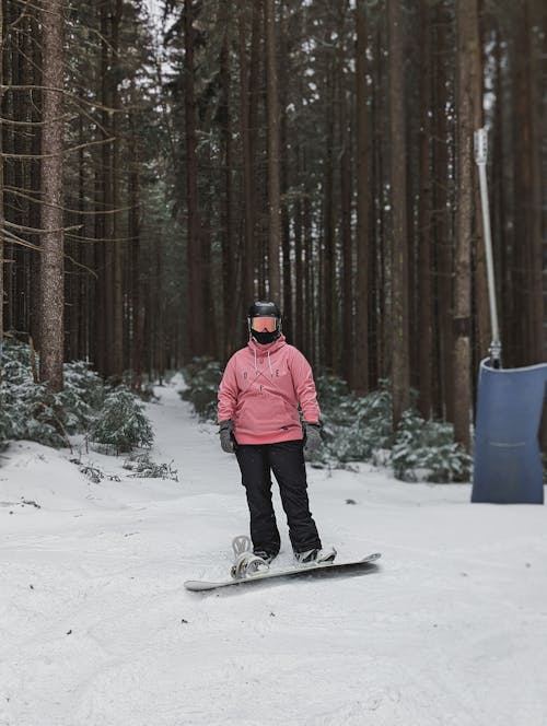 A Person Snowboarding Wearing Safety Gears