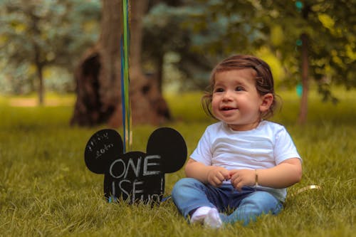 Free Baby Sitting on Lawn Grass Stock Photo