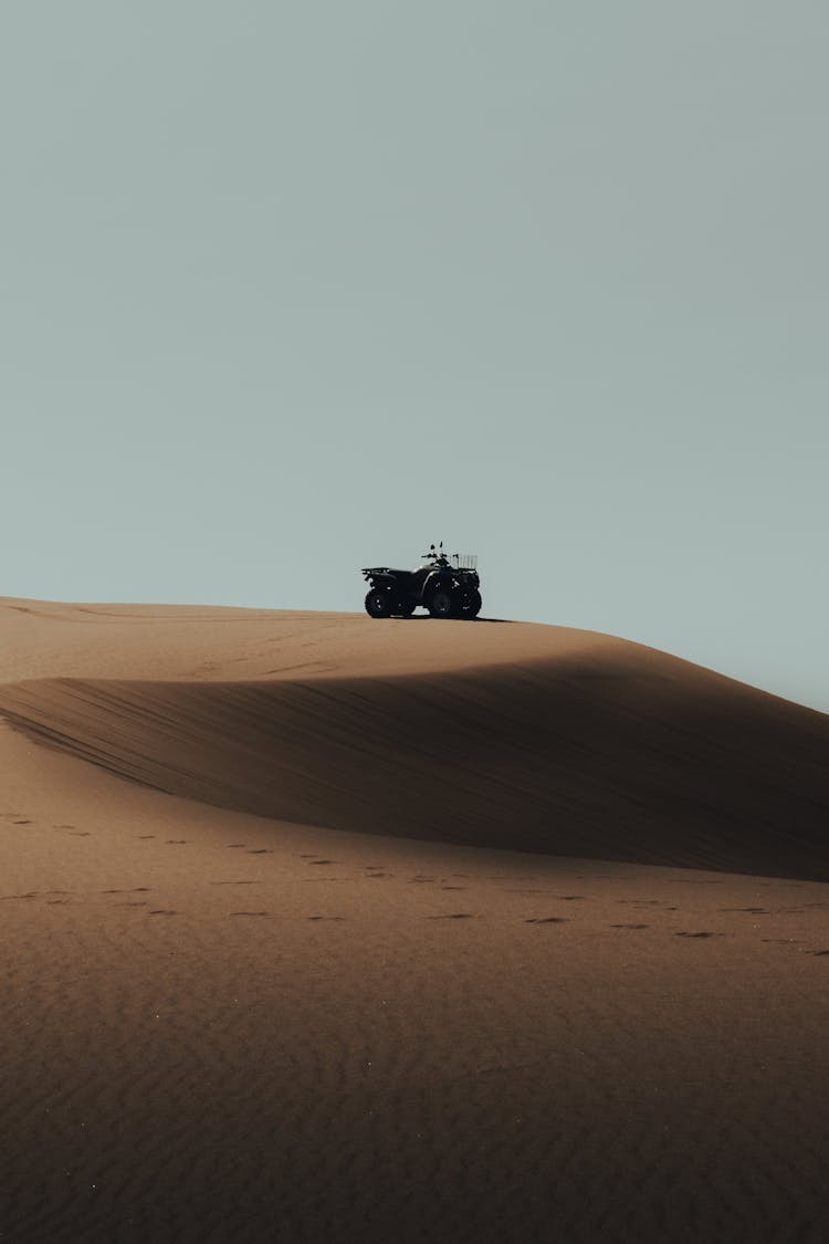 A Black Dune Buggy On Brown Sand