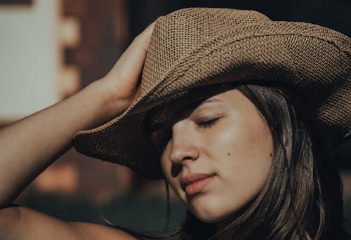 Woman Wearing Brown Cowboy Hat with Eyes Closed