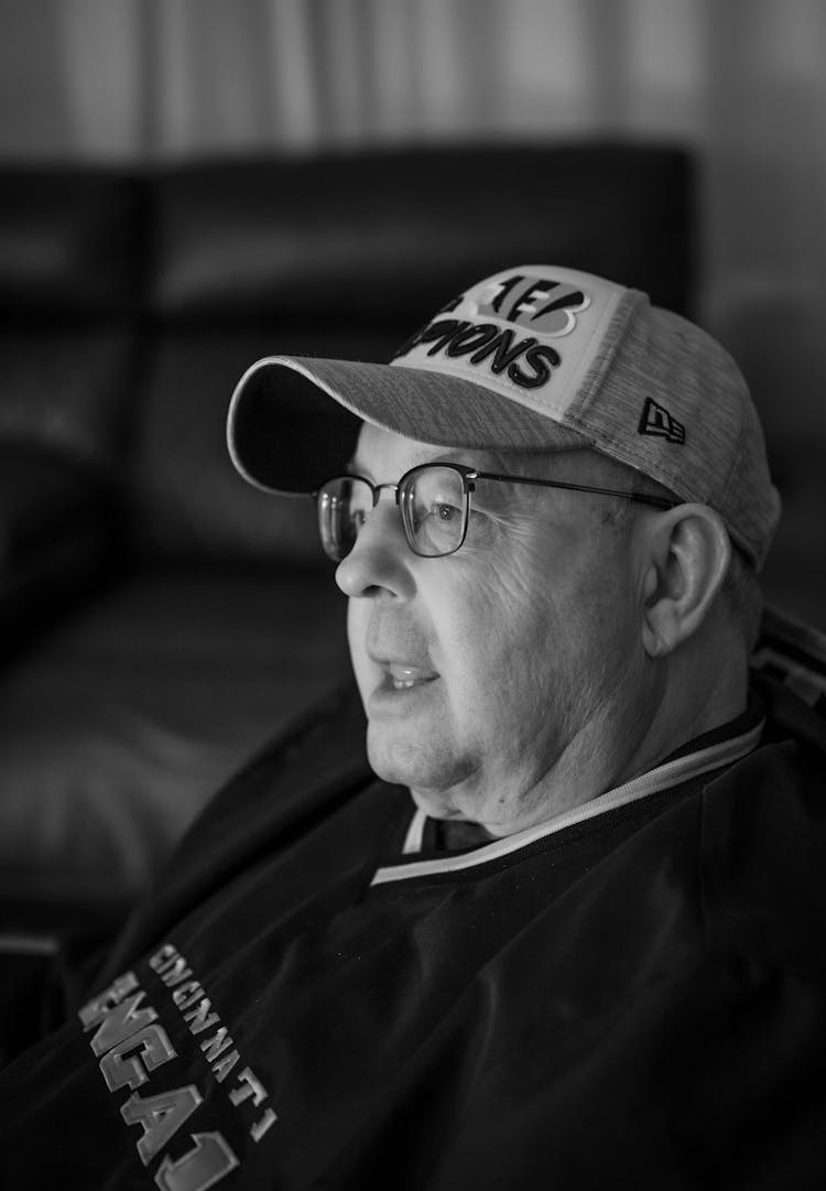 Grayscale Photo Of A Man Wearing Baseball Cap      