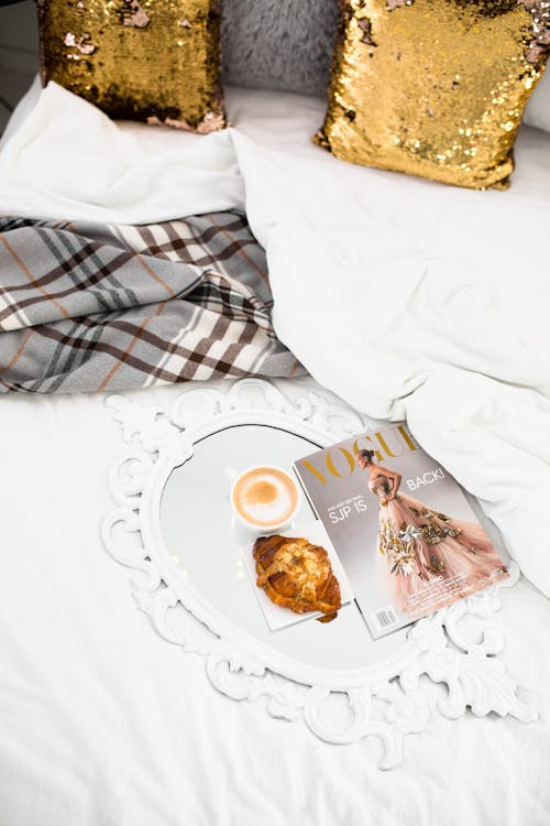 A Tray with Delicious Cup of Coffee and Bread on Bed
