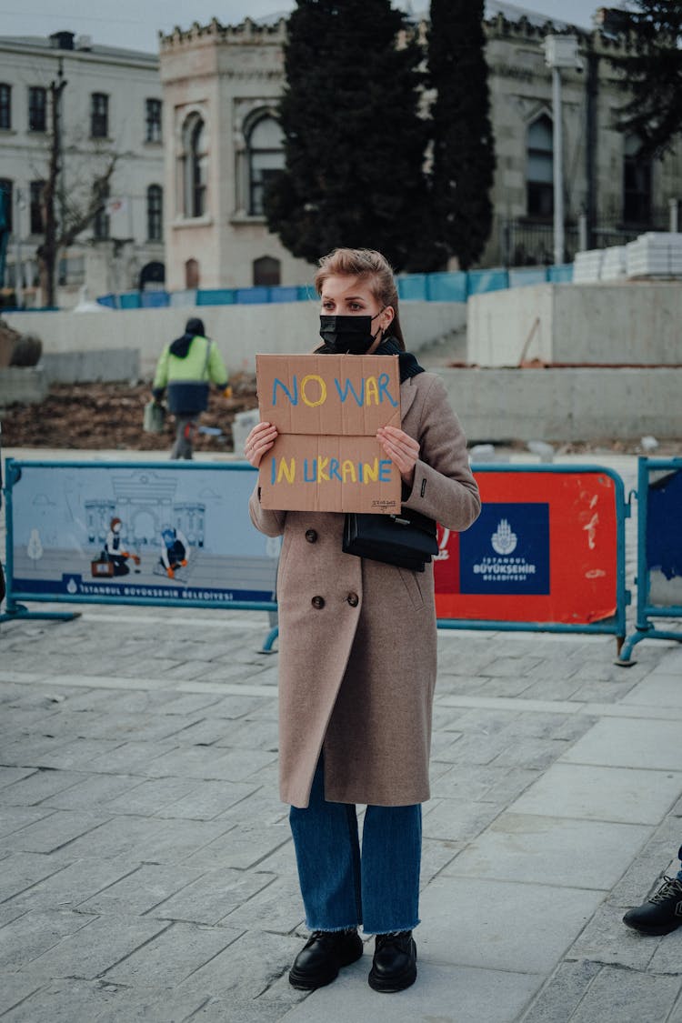 A Woman Holding A No War In Ukraine Sign