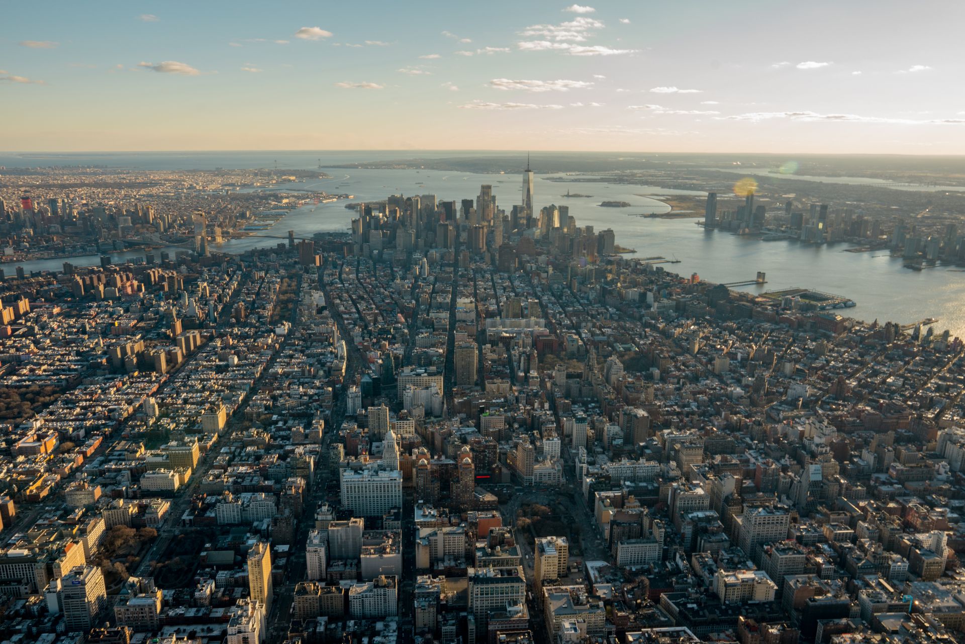 Stunning aerial panorama of New York City skyline at dusk showcasing skyscrapers and waterways.
