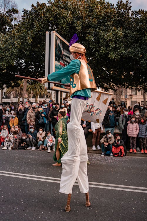 People Watching a Performer on a Parade