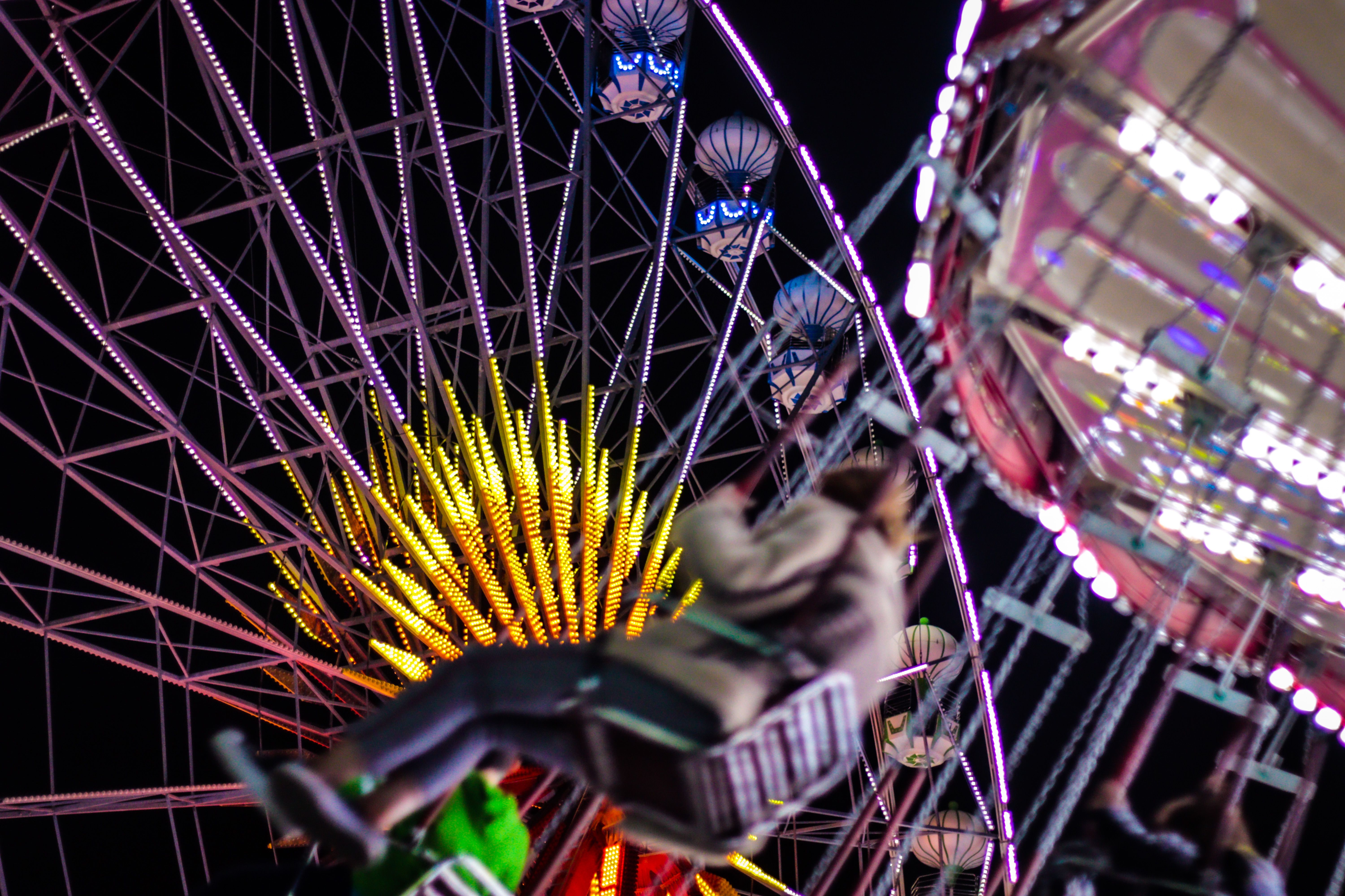 A Person Riding a Swing Ride · Free Stock Photo