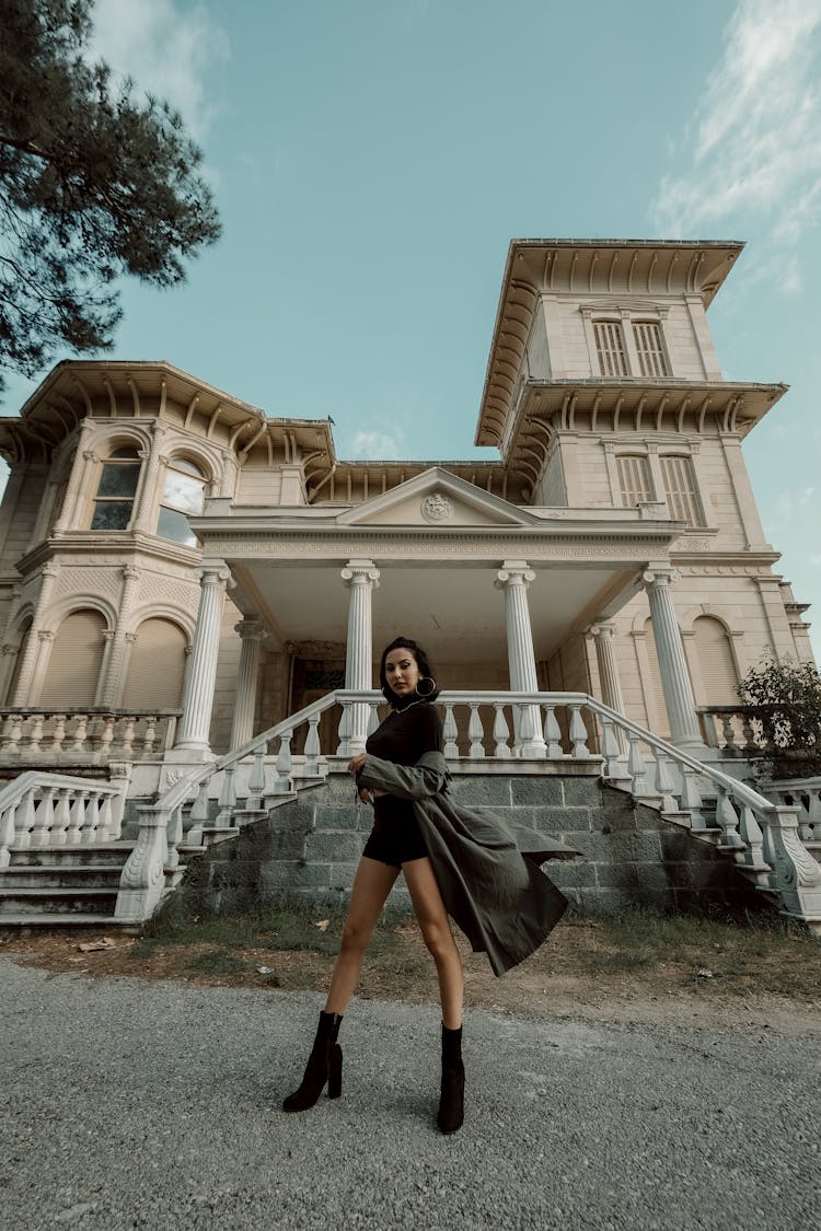 A Woman Standing In Front Of A House