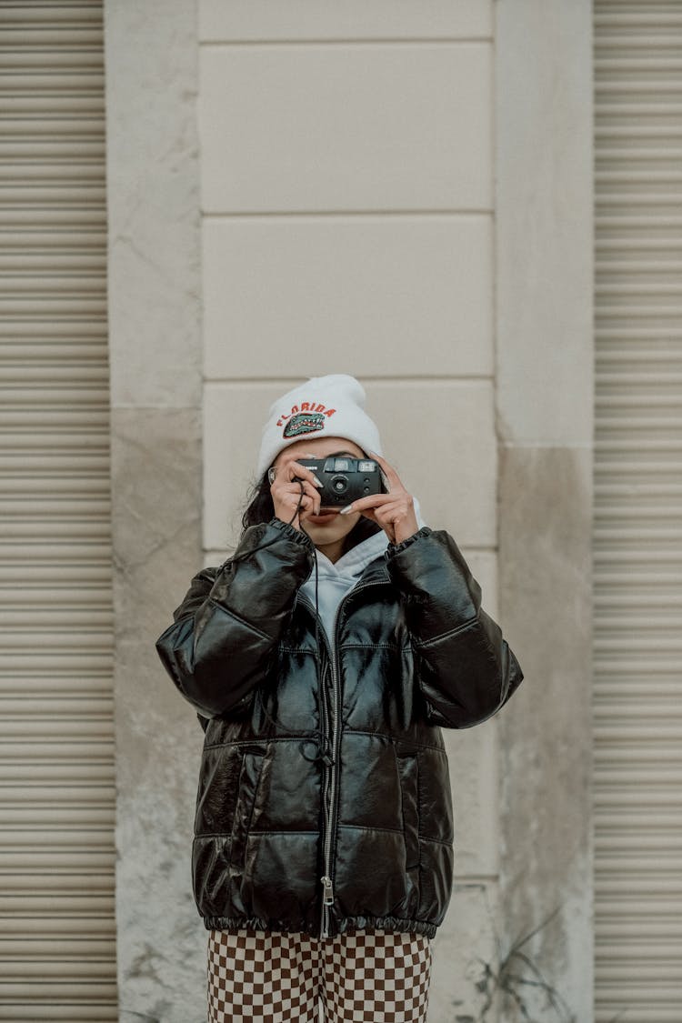 Woman Taking Photo With Analog Camera