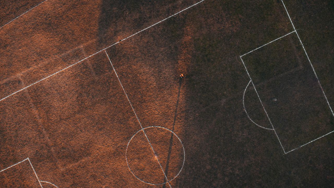 aerial drone shot of a soccer field highlighting markings and textures