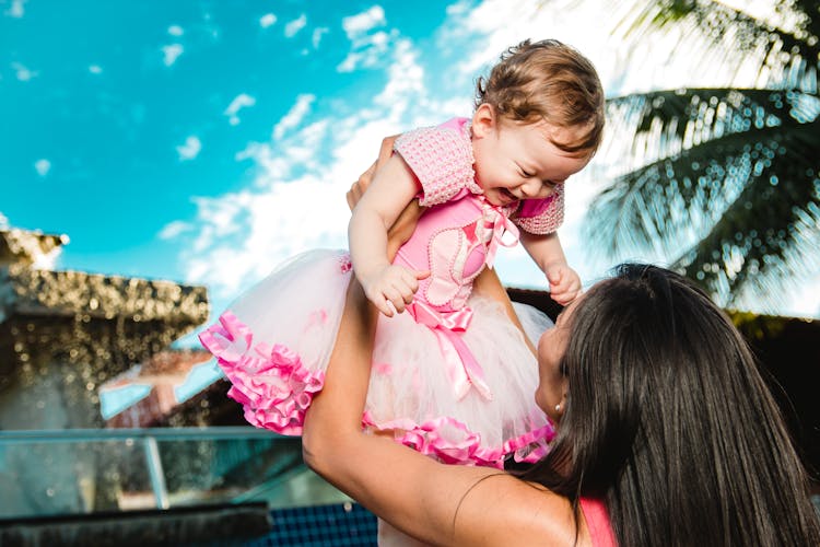 Woman Holding Baby Above Head