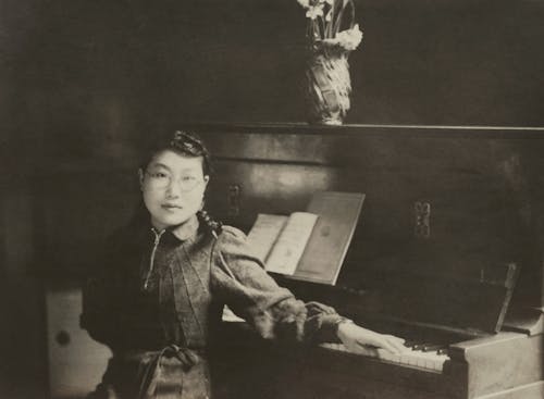 Young Woman Sitting At Piano