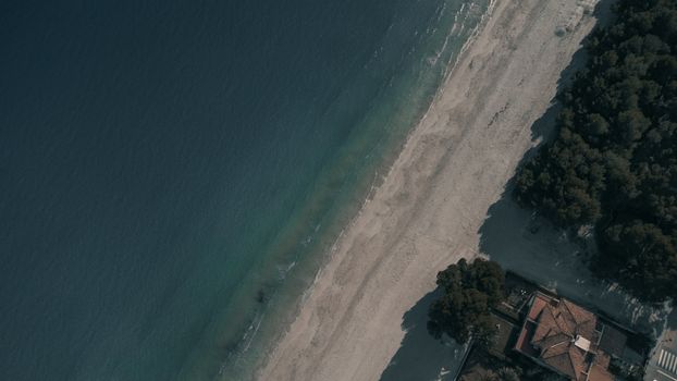 A stunning aerial view of Port d'Alcúdia beach in Spain, showcasing the clear blue sea and sandy shore.