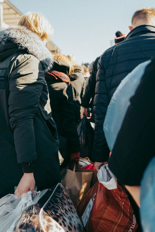 Free A group of people in warm clothing carrying bags in a crowded street of Vilnius, Lithuania. Stock Photo