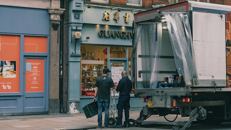 Delivery Men In Front Of A Store