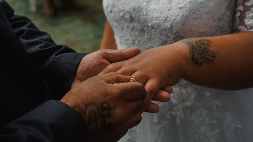 Free Close-up of a couple exchanging rings during a wedding ceremony, symbolizing love. Stock Photo