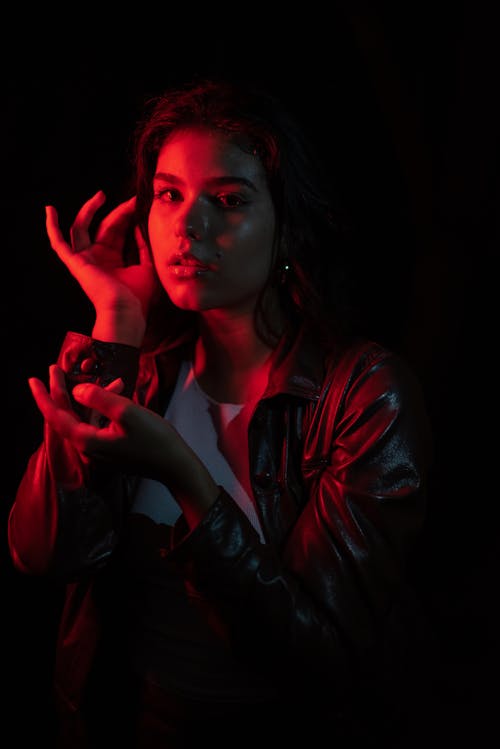 Woman in Leather Jacket Posing in Red Light