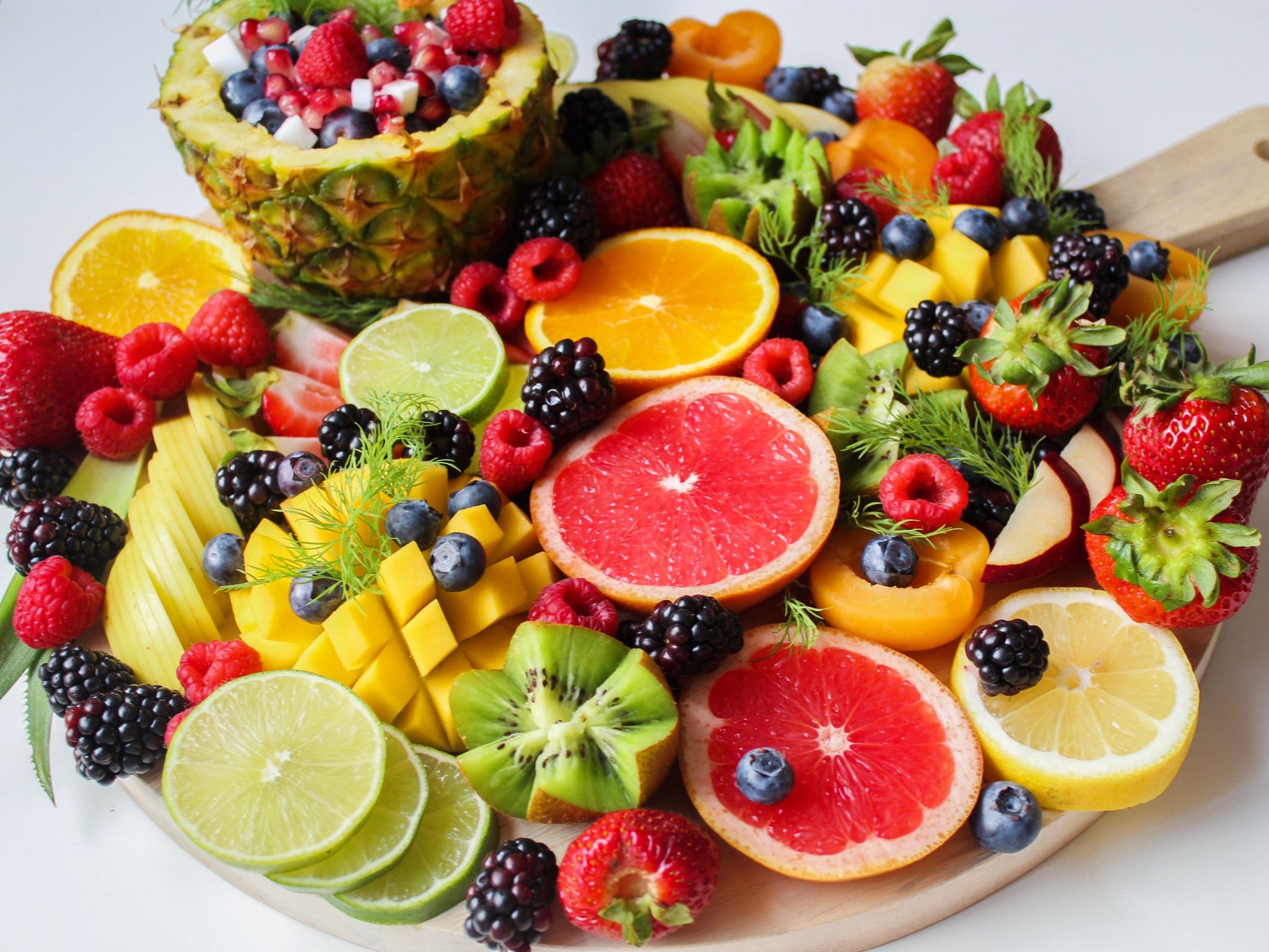 Bowl of seasonal fruit on wooden table