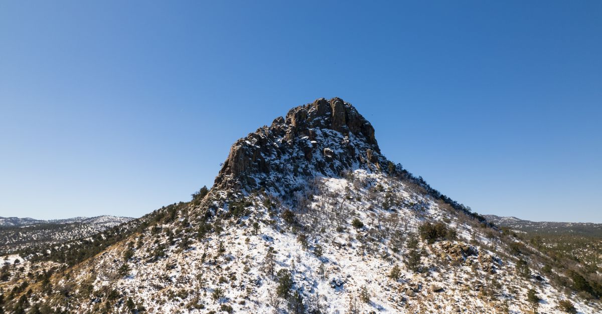 Stunning winter view of Thumb Butte under a clear blue sky in Prescott.