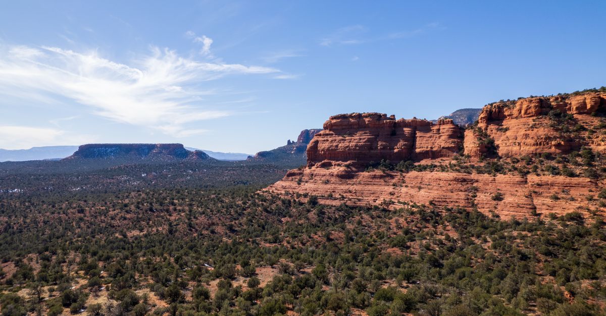 Explore the stunning red rock formations of Sedona under a clear blue sky.