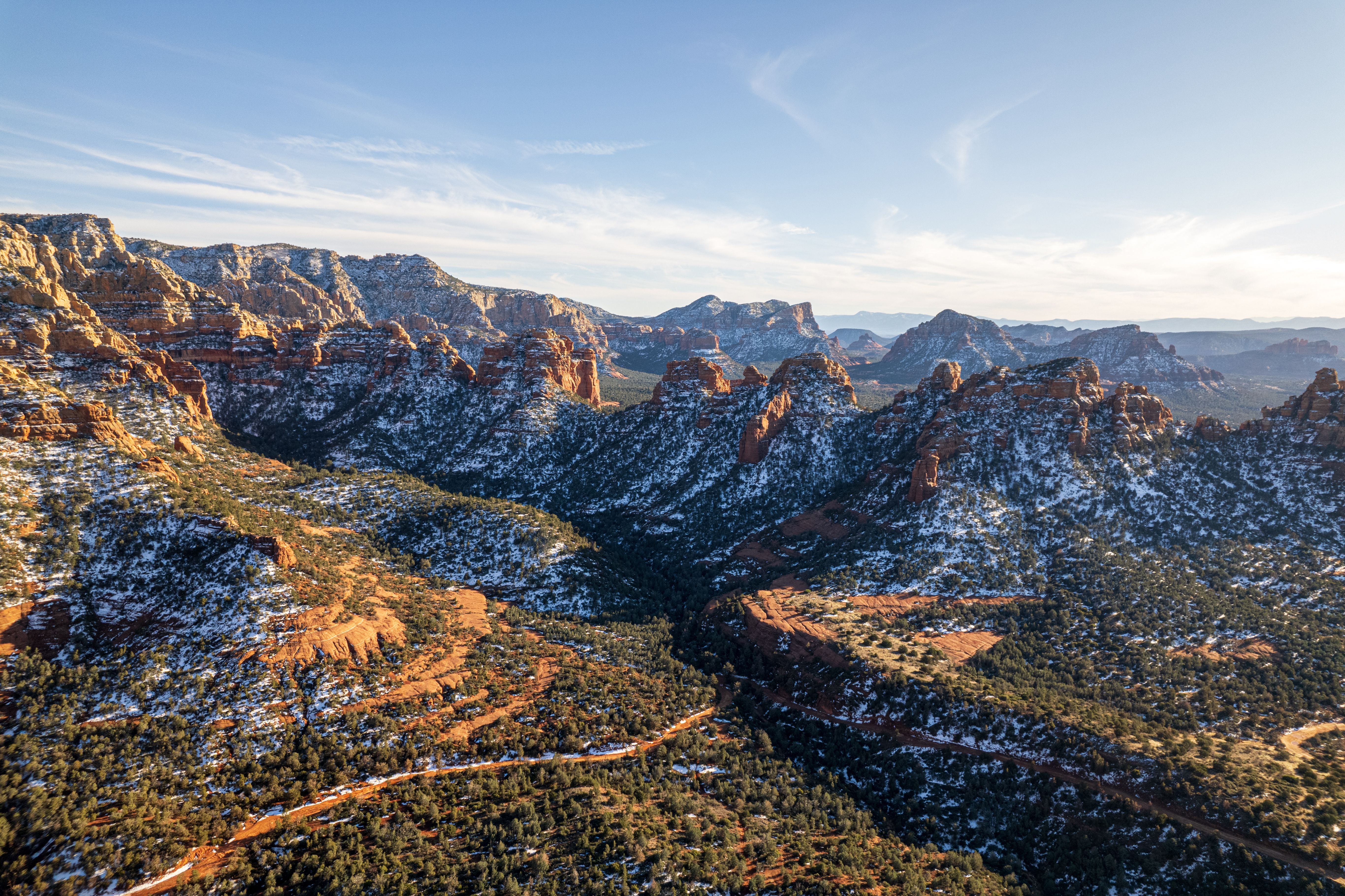 Sedona Arizona slickrock trail, Bell Rock visible on the valley floor