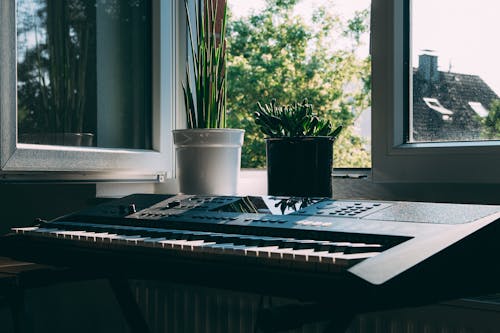 Black Electronic Keyboard Near Window