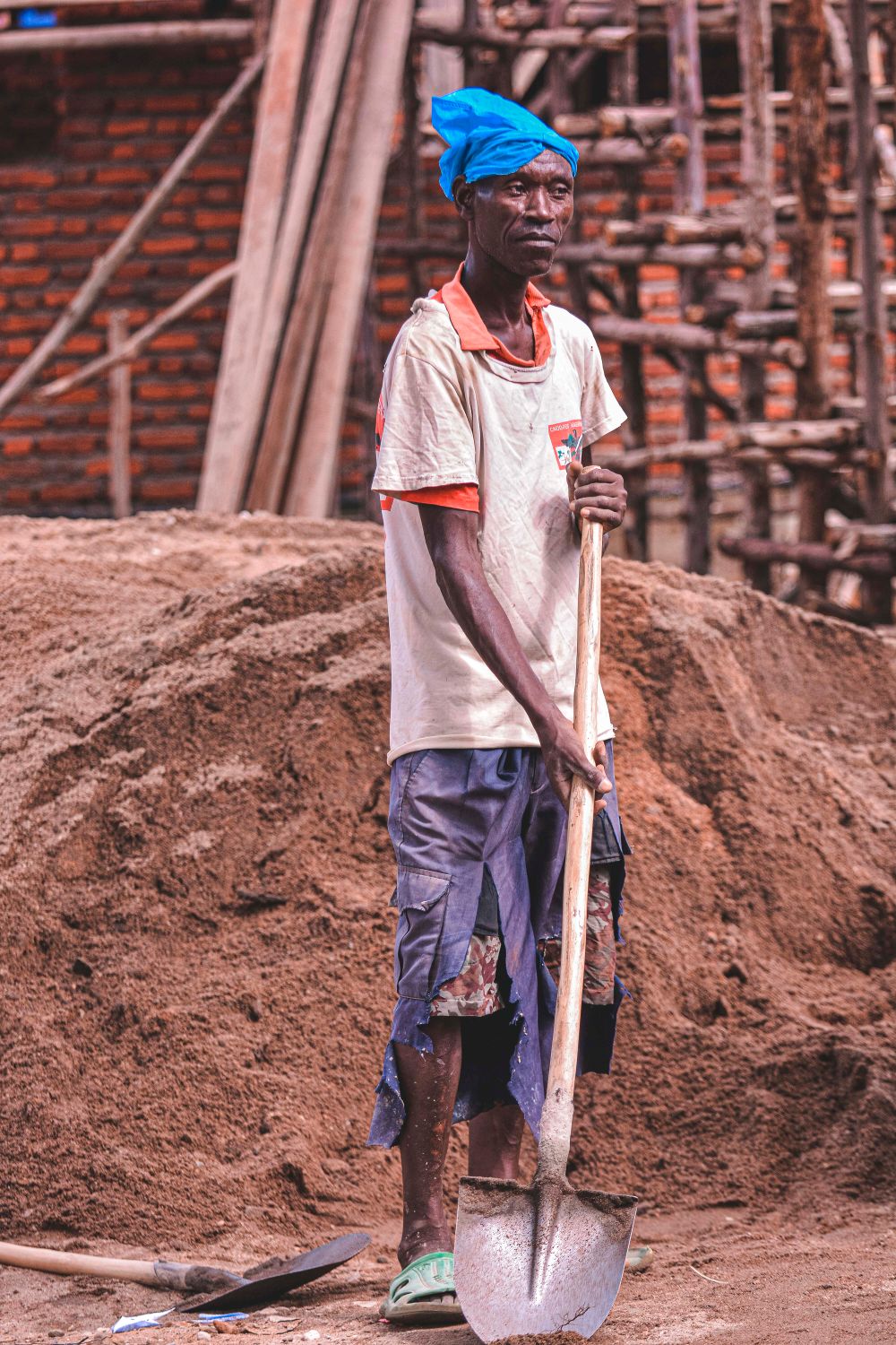 A Male Laborer Holding a Shovel · Free Stock Photo