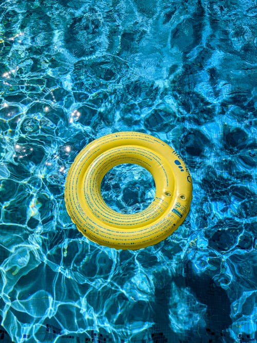 Free Yellow Swim Ring on Swimming Pool Stock Photo