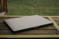 Silver Macbook on Brown Wooden Table