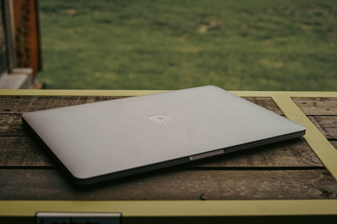 Silver Macbook on Brown Wooden Table · Free Stock Photo