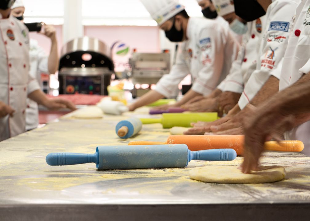 Best Cooking Academy in Ahmedabad: 6 Things to Check Before You Enrol (2026) 1 Culinary school students in white chef uniforms practising dough techniques in a professional baking class.