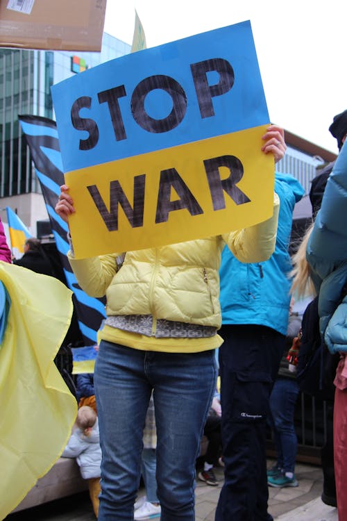 Free A Person Holding a Stop War Poster during a Peaceful Protest Stock Photo