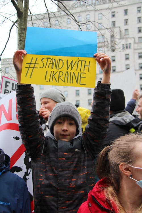 A Boy Supporting Ukraine in a Rally 