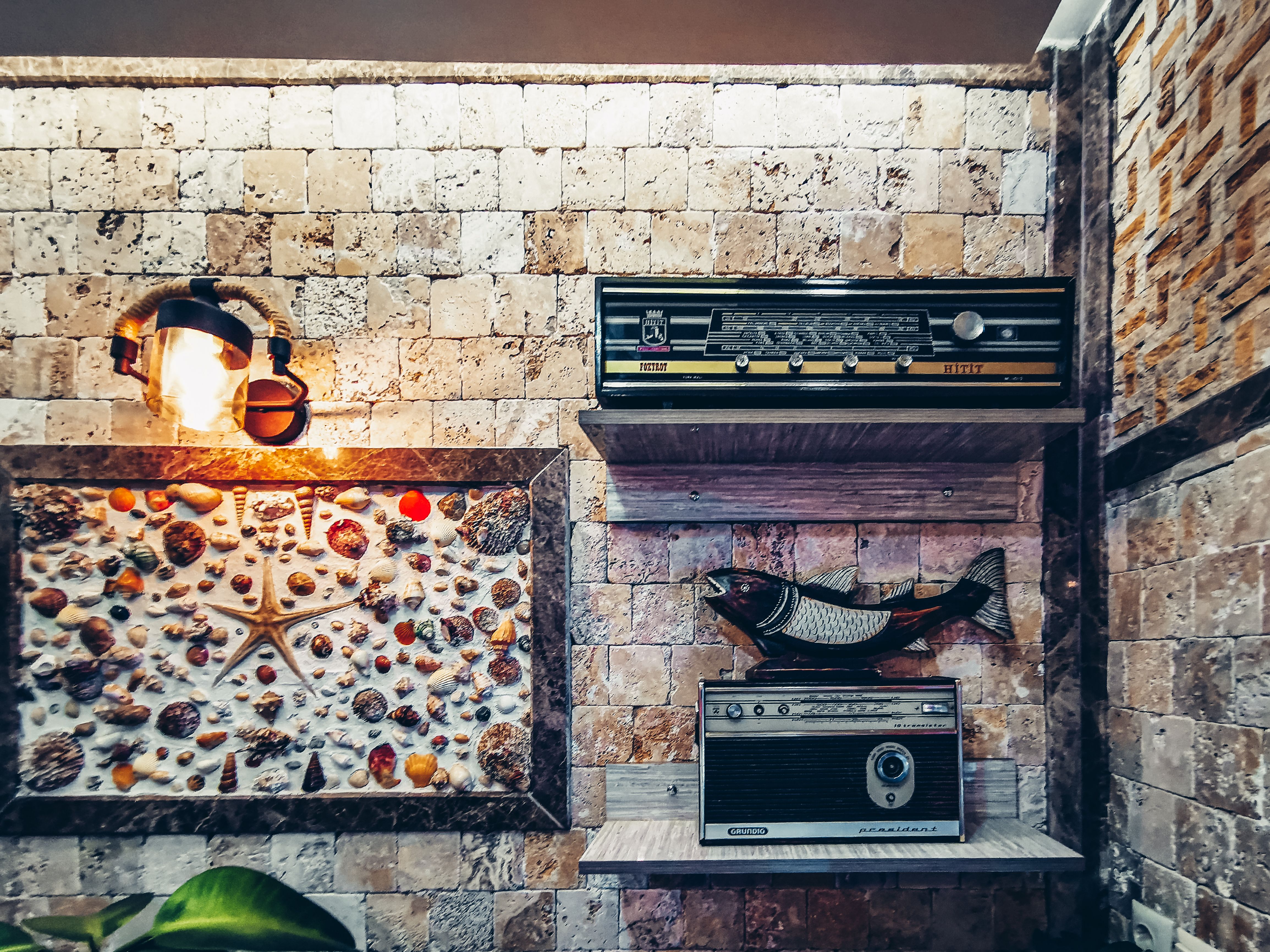 A stylish vintage corner featuring retro radios and artistic wall decor in Arsuz, Turkey.