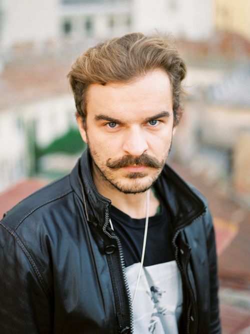 Free A man in a leather jacket with a stylish moustache looking directly at the camera. Stock Photo