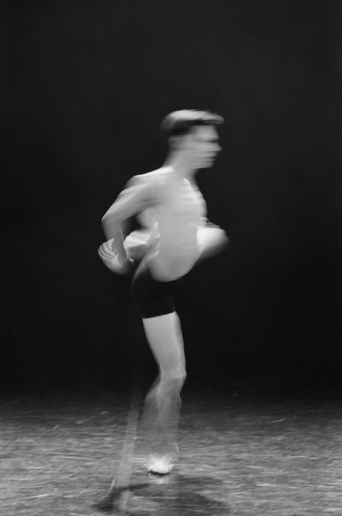 Free Blurred artistic black and white image of a male ballet dancer in motion, capturing grace and speed. Stock Photo