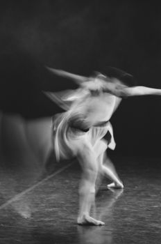 A captivating long exposure shot of a ballet dancer in motion, highlighting grace and fluidity.