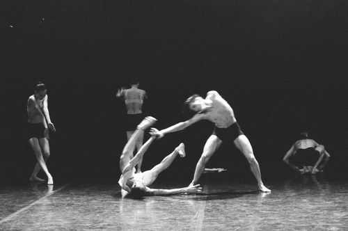 Free Black and white image capturing an expressive group dance performance on stage. Stock Photo