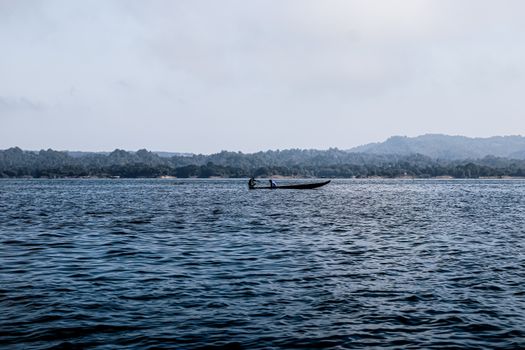 Person Riding on White and Black Boat on Sea
